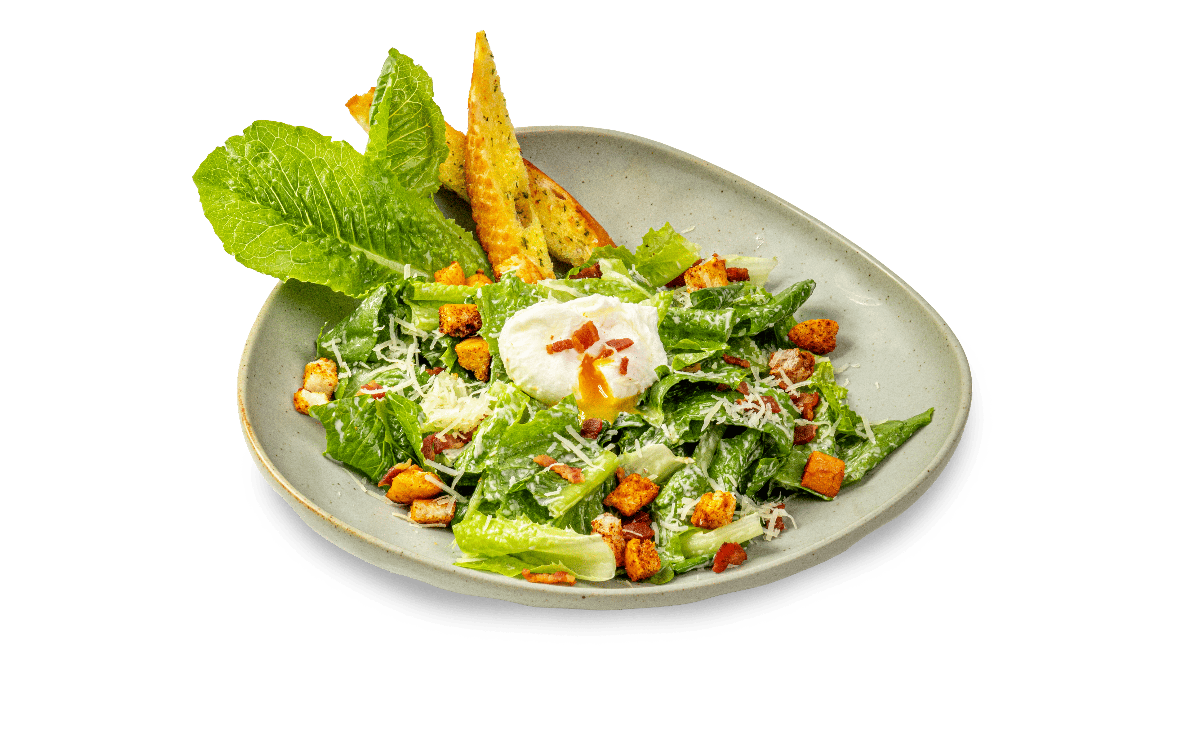 Salad Caesar với xà lách thái nhỏ, bánh mỳ nướng, thịt ba chỉ xông khói, trứng chần, trộn xôt kem và phô mai Parmesan.