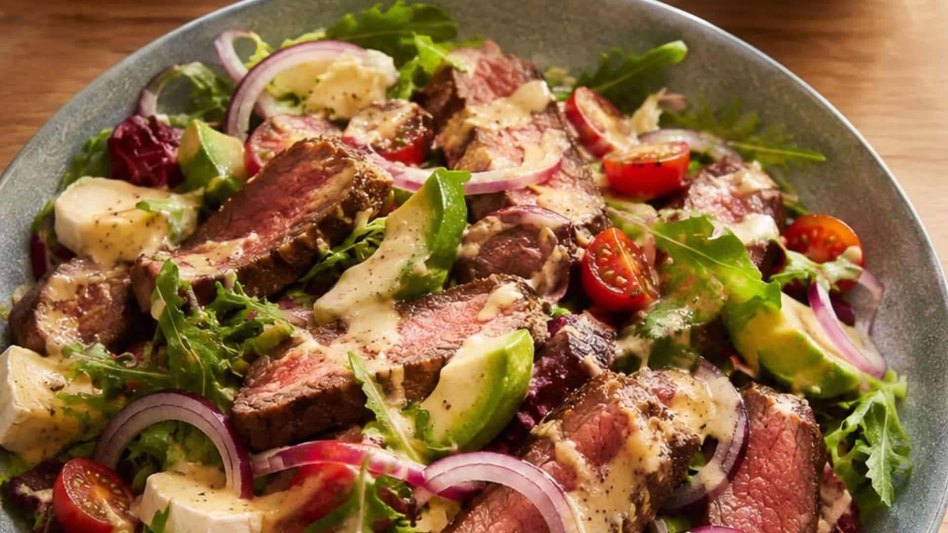 Salad thịt bò xốt mè rang nổi bật với vị béo nhẹ và hương thơm đặc trưng của mè, hòa quyện cùng thịt bò và rau củ tươi.